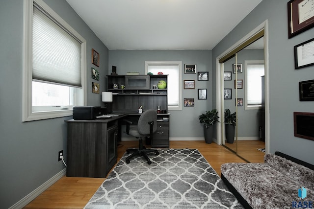 office area with baseboards and wood finished floors