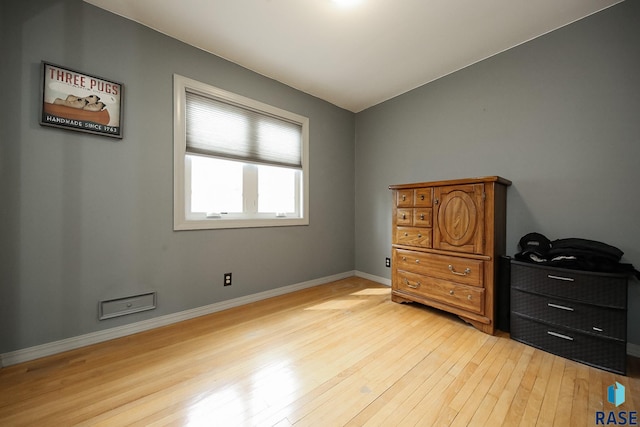 bedroom with light wood-style floors and baseboards