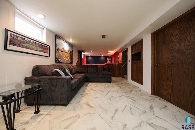 living room featuring visible vents and marble finish floor