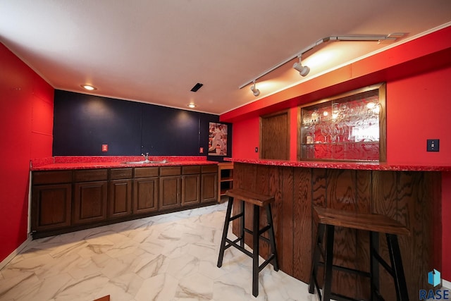 bar featuring marble finish floor, recessed lighting, rail lighting, a sink, and wet bar