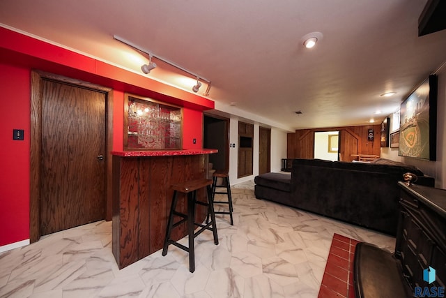 bar featuring a bar and marble finish floor