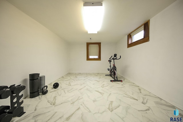 workout area featuring marble finish floor