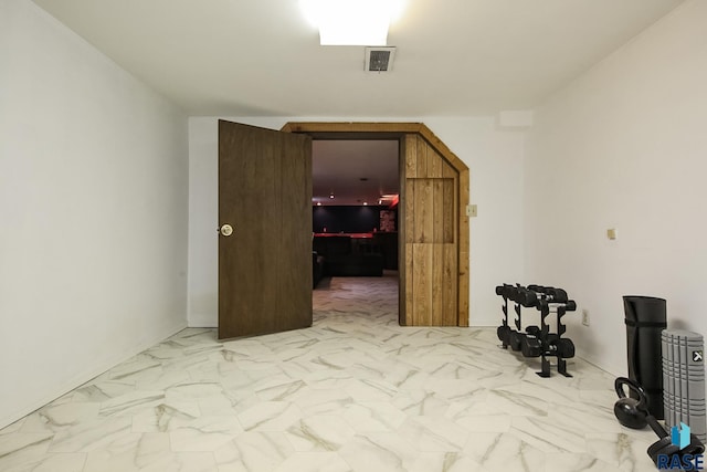 unfurnished room with visible vents and marble finish floor