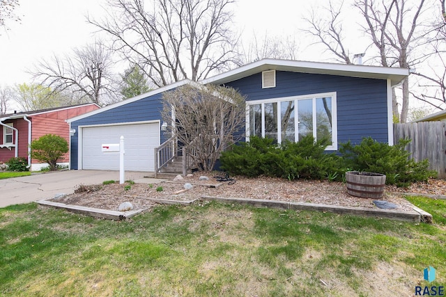 view of front of home featuring a detached garage and fence