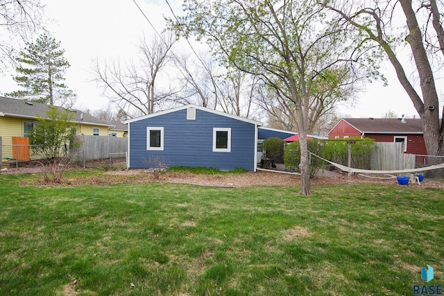 exterior space with fence and a yard