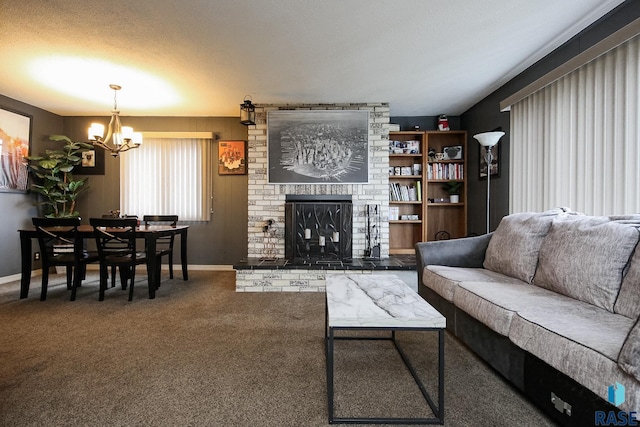 carpeted living area with baseboards, a fireplace, and a notable chandelier