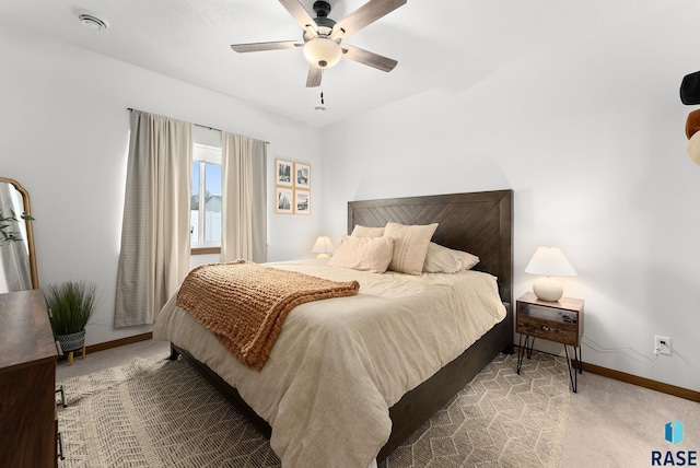 bedroom featuring baseboards, ceiling fan, and carpet