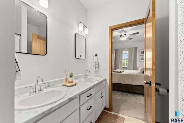 bathroom featuring double vanity, a ceiling fan, a sink, and ensuite bath