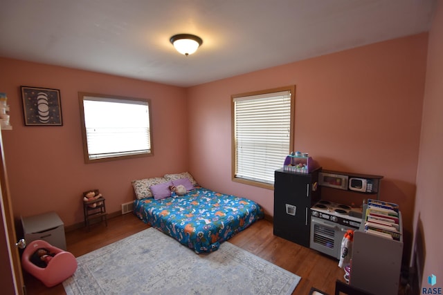 bedroom with wood finished floors