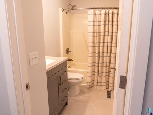 bathroom with toilet, tile patterned floors, shower / tub combo with curtain, and vanity
