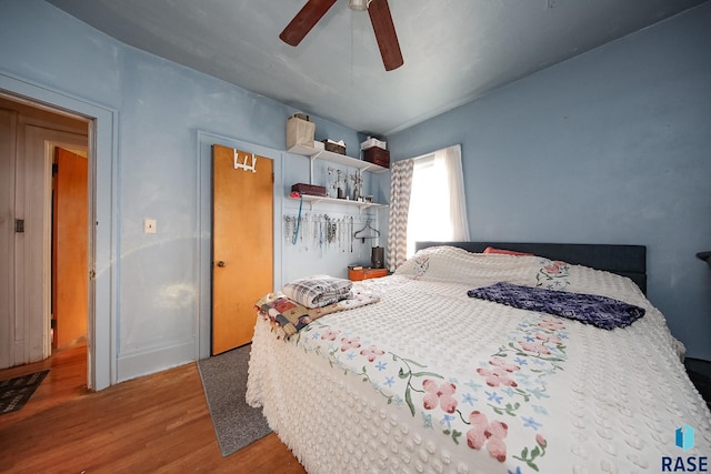 bedroom with ceiling fan and wood finished floors