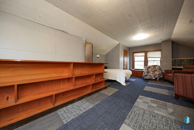 bedroom with dark carpet and vaulted ceiling