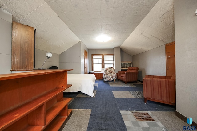 bedroom with dark colored carpet and vaulted ceiling