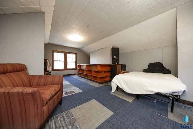 bedroom featuring carpet and lofted ceiling