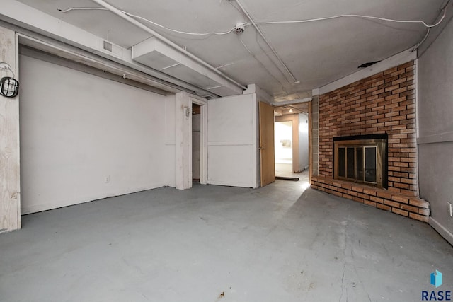 below grade area featuring a brick fireplace