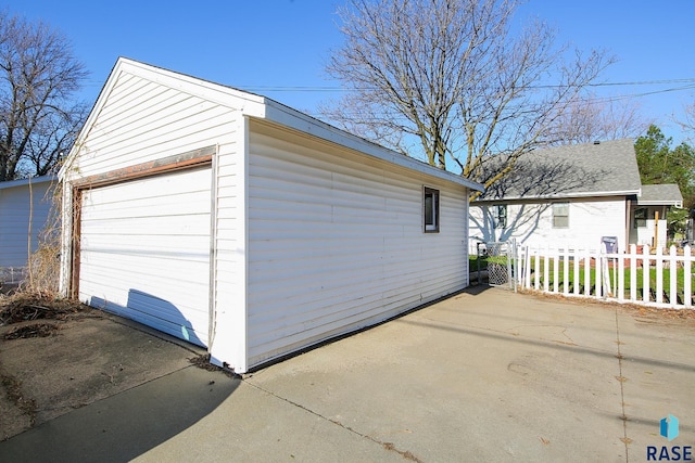 detached garage featuring fence