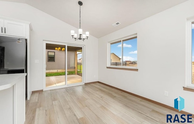 1125 E Wayne Pl, Tea, SD 57064 - unfurnished dining area featuring lofted ceiling, plenty of natural light, light wood-style flooring, a chandelier, and baseboards