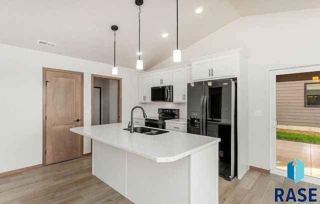 1125 E Wayne Pl, Tea, SD 57064 - kitchen with black appliances, a sink, vaulted ceiling, light wood-type flooring, and white cabinetry