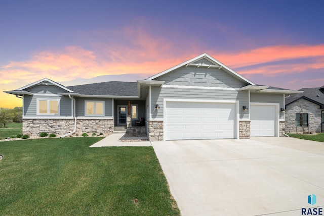 922 Johnson Creek Ct, Harrisburg, SD 57032 - view of front facade with a garage, driveway, stone siding, a lawn, and roof with shingles
