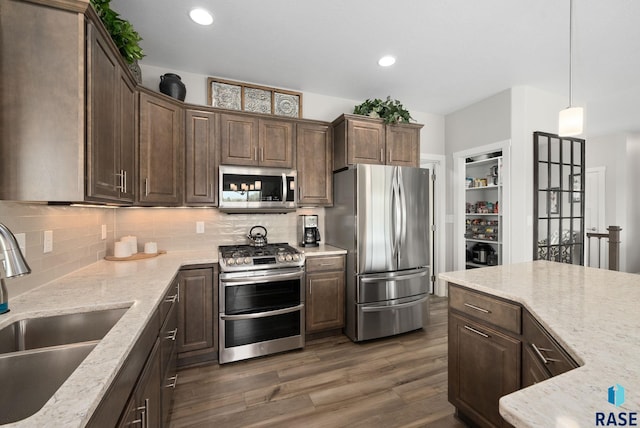 922 Johnson Creek Ct, Harrisburg, SD 57032 - kitchen with stainless steel appliances, a sink, decorative backsplash, dark wood-style floors, and recessed lighting