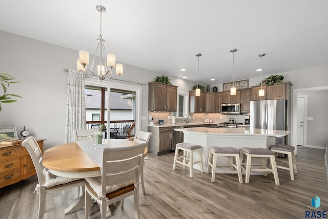 922 Johnson Creek Ct, Harrisburg, SD 57032 - dining space with a chandelier, light wood-style floors, and recessed lighting