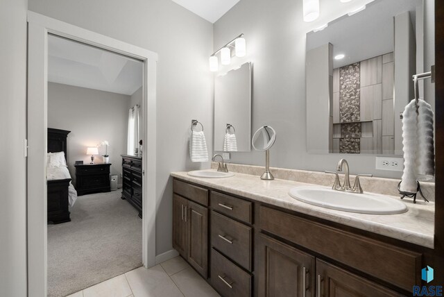 922 Johnson Creek Ct, Harrisburg, SD 57032 - ensuite bathroom featuring double vanity, tile patterned flooring, and baseboards