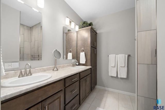 922 Johnson Creek Ct, Harrisburg, SD 57032 - bathroom featuring tile patterned floors, double vanity, and baseboards