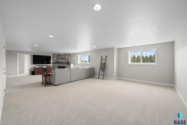 922 Johnson Creek Ct, Harrisburg, SD 57032 - living room with a stone fireplace, baseboards, carpet flooring, and recessed lighting