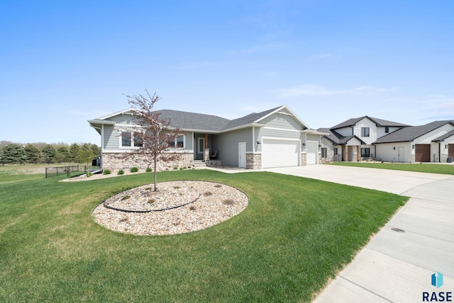 922 Johnson Creek Ct, Harrisburg, SD 57032 - view of front of property featuring stone siding, a garage, and concrete driveway