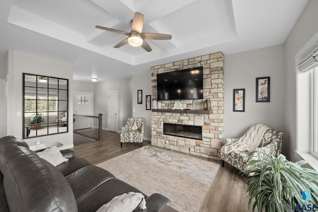 922 Johnson Creek Ct, Harrisburg, SD 57032 - living area with wood finished floors, ceiling fan, a tray ceiling, a fireplace, and baseboards