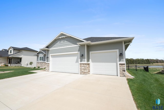 922 Johnson Creek Ct, Harrisburg, SD 57032 - craftsman house featuring stone siding, a front lawn, a garage, and concrete driveway
