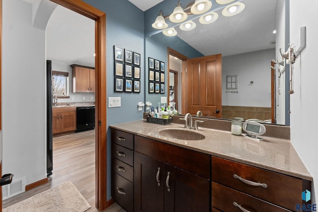bathroom with visible vents, wood finished floors, and vanity