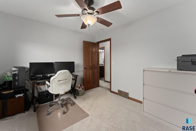 carpeted home office with visible vents, baseboards, and ceiling fan