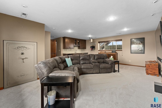 living room featuring baseboards, light carpet, recessed lighting, and visible vents