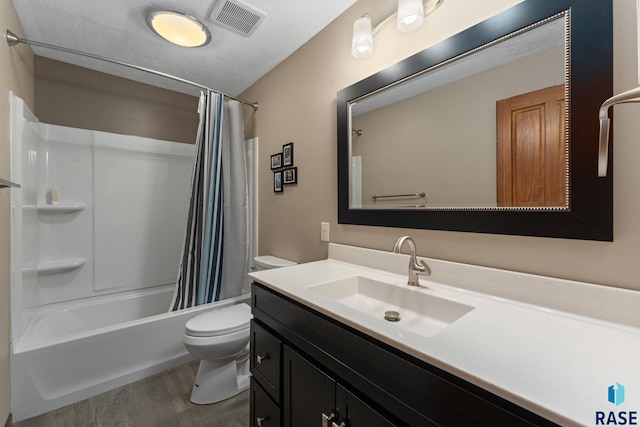 bathroom featuring visible vents, wood finished floors, vanity, toilet, and shower / bathtub combination with curtain