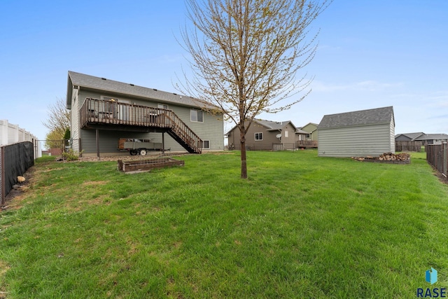 view of yard featuring a fenced backyard, a wooden deck, and stairs