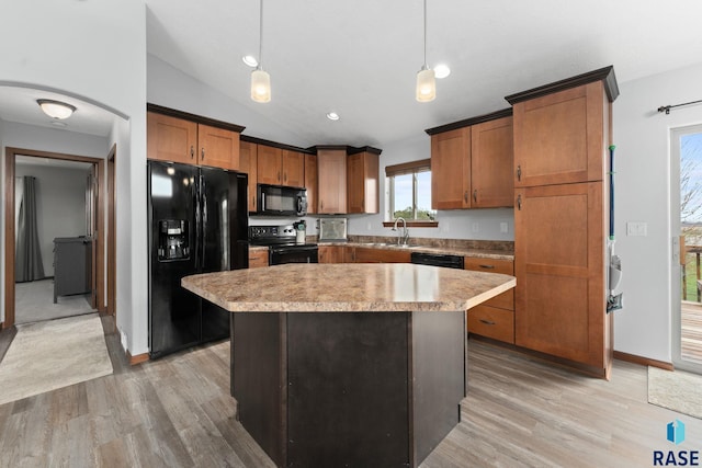 kitchen with light wood-style floors, a sink, lofted ceiling, and black appliances