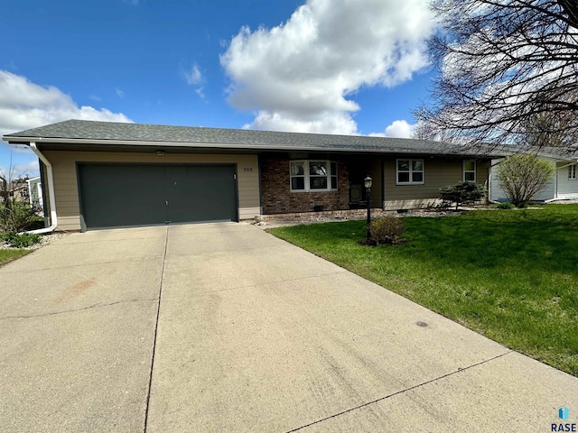 ranch-style house featuring a garage, driveway, and a front lawn