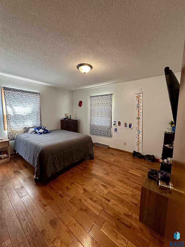 bedroom featuring a textured ceiling and hardwood / wood-style flooring