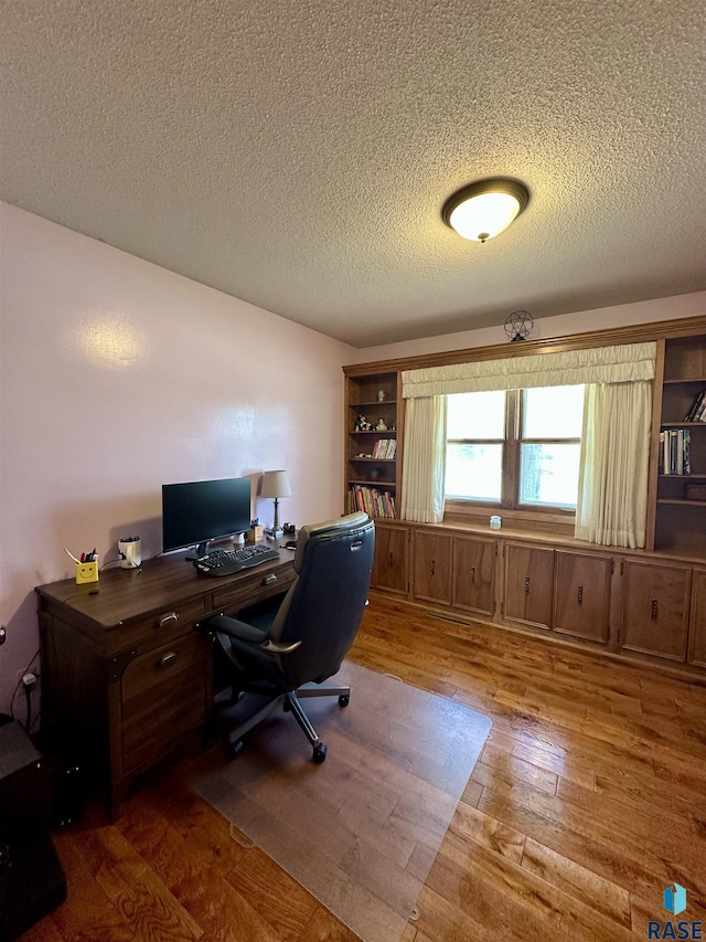 office space featuring a textured ceiling and hardwood / wood-style floors