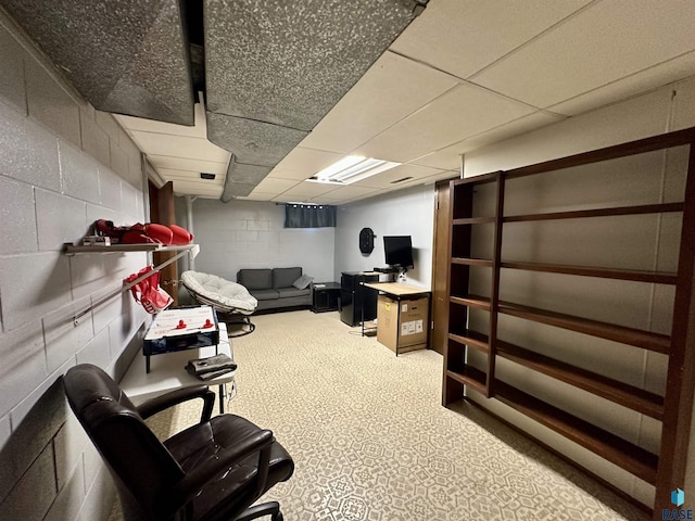 office with concrete block wall and a paneled ceiling