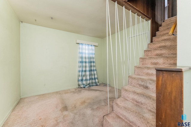stairs featuring carpet floors and baseboards