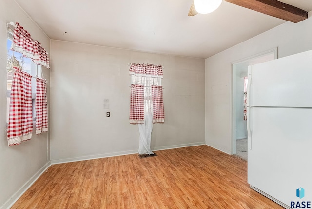 unfurnished room with light wood-style floors and baseboards