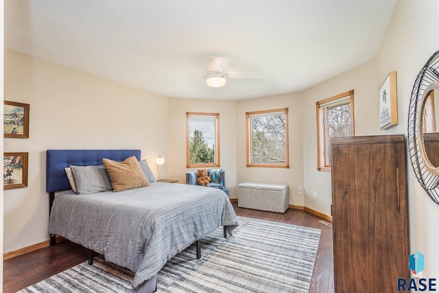 bedroom with baseboards, ceiling fan, and wood finished floors
