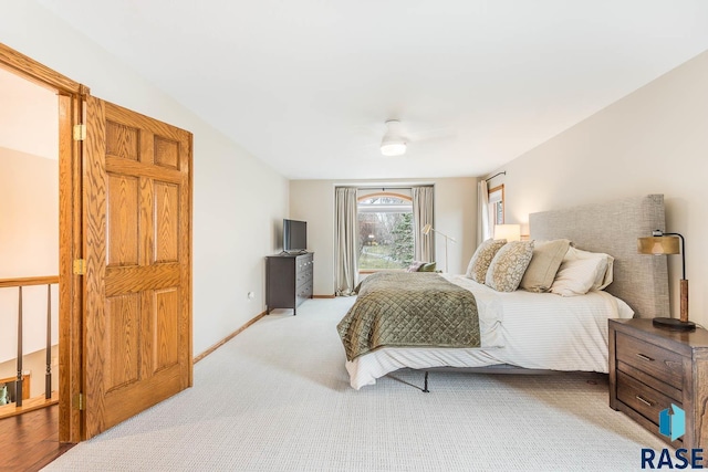 bedroom with baseboards, light carpet, and ceiling fan