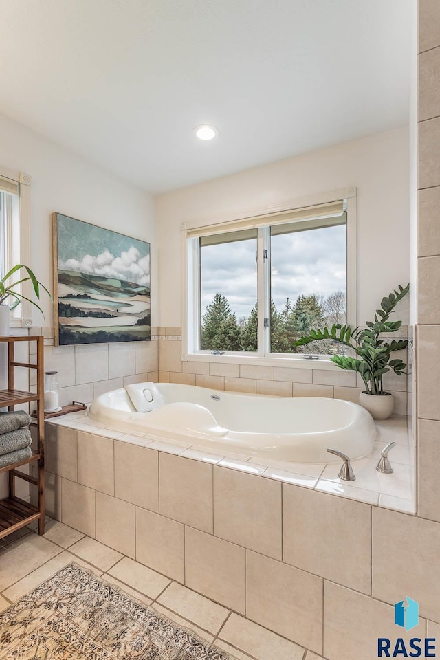 bathroom featuring tile patterned flooring and a bath