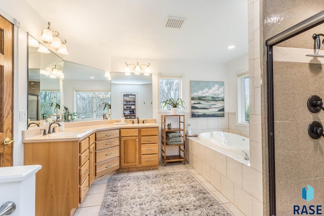 full bath featuring tile patterned floors, visible vents, a tile shower, and a sink