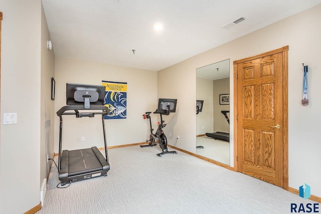 exercise room with carpet flooring, baseboards, and visible vents
