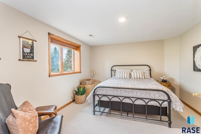 bedroom featuring baseboards, carpet flooring, and visible vents