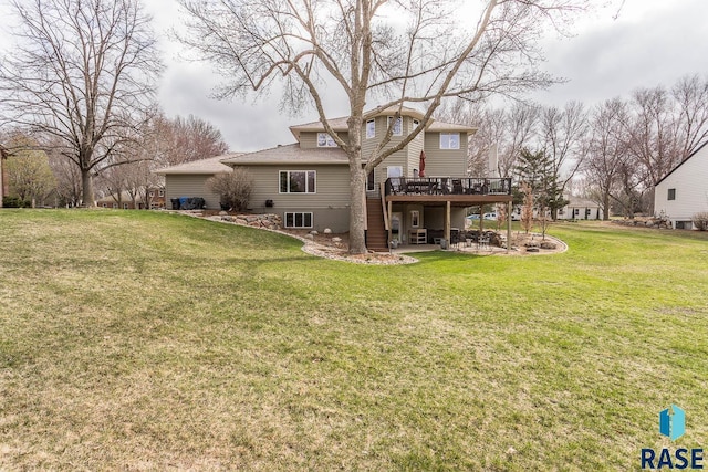 back of property featuring a lawn, a deck, a patio, and roof with shingles